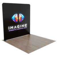 A trade show backdrop with the text 'IMAGINE EXPERIENTIAL GRAPHIC DESIGN' and an abstract globe graphic, set against a plain indoor setting.