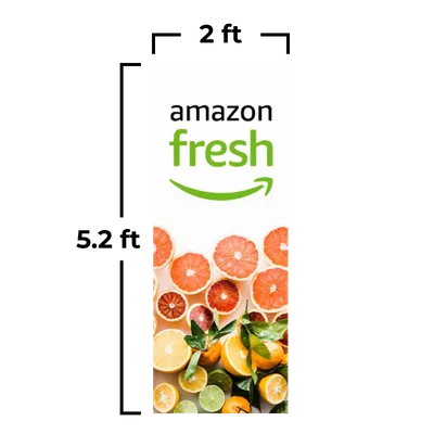 Logo of 'Amazon Fresh' above a variety of citrus fruits—sliced oranges, grapefruits, and lemons—against a white background.